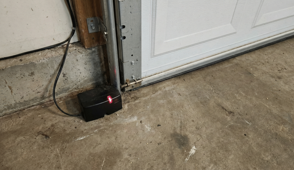 garage door safety sensor positioned near the lower track