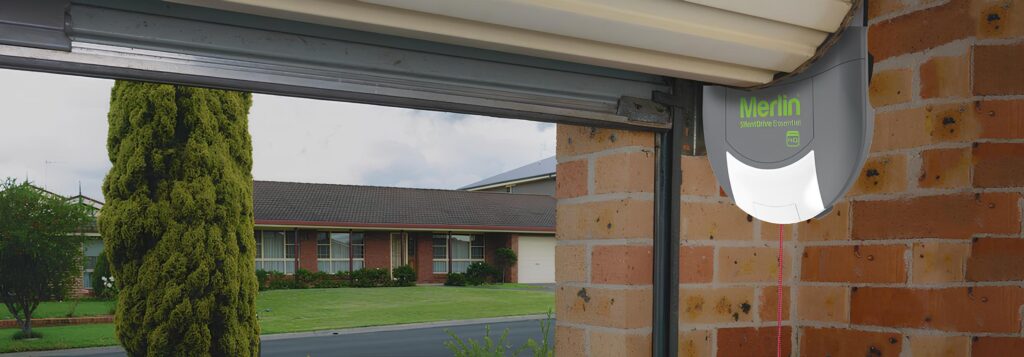 Merlin garage door motor on brick wall.