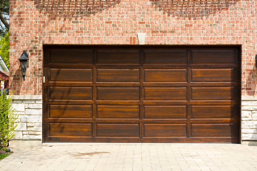 Timber garage door on brick house exterior