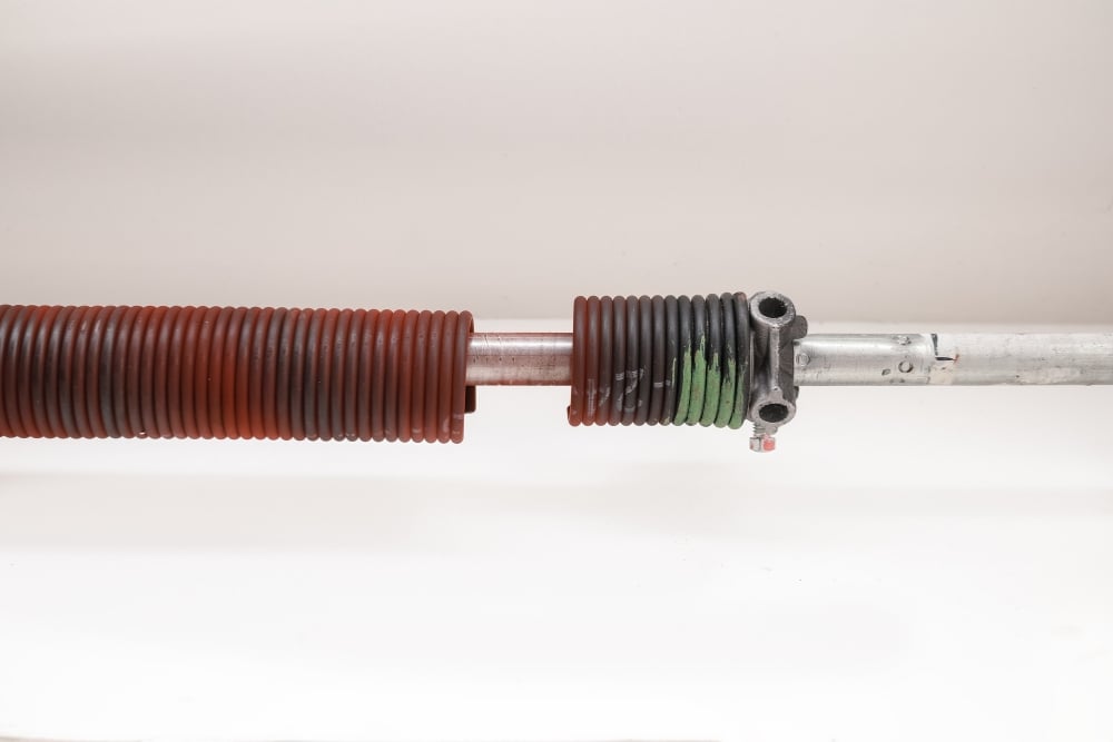 Garage door torsion spring on metal shaft