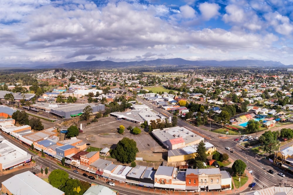 Aerial view of suburban town with mountains backdrop