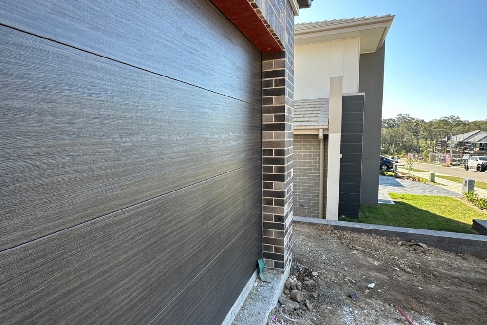 Modern home exterior with garage and brick wall