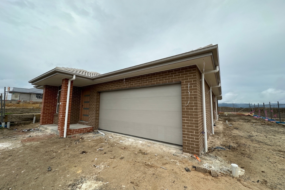 New brick house with double garage under construction