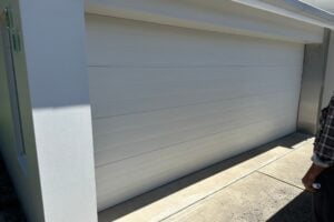 White sectional garage door on modern home driveway