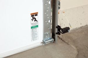 Garage door safety sensor and warning label
