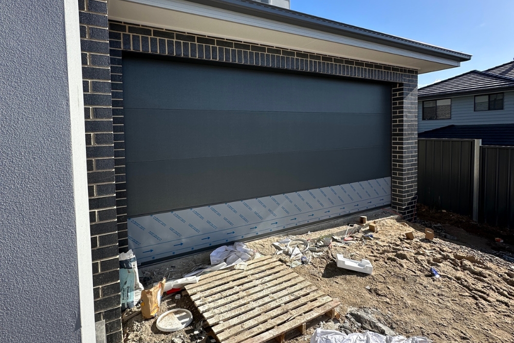 New brick house garage with dark grey door